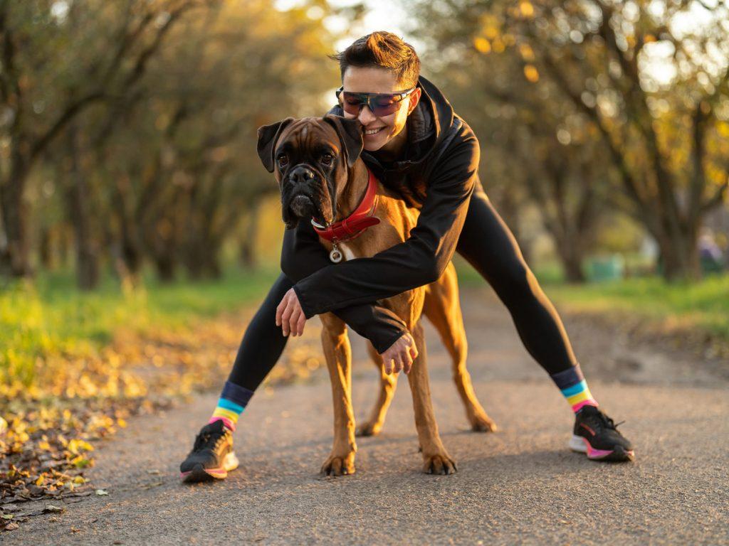 Woman hugging large boxer dog