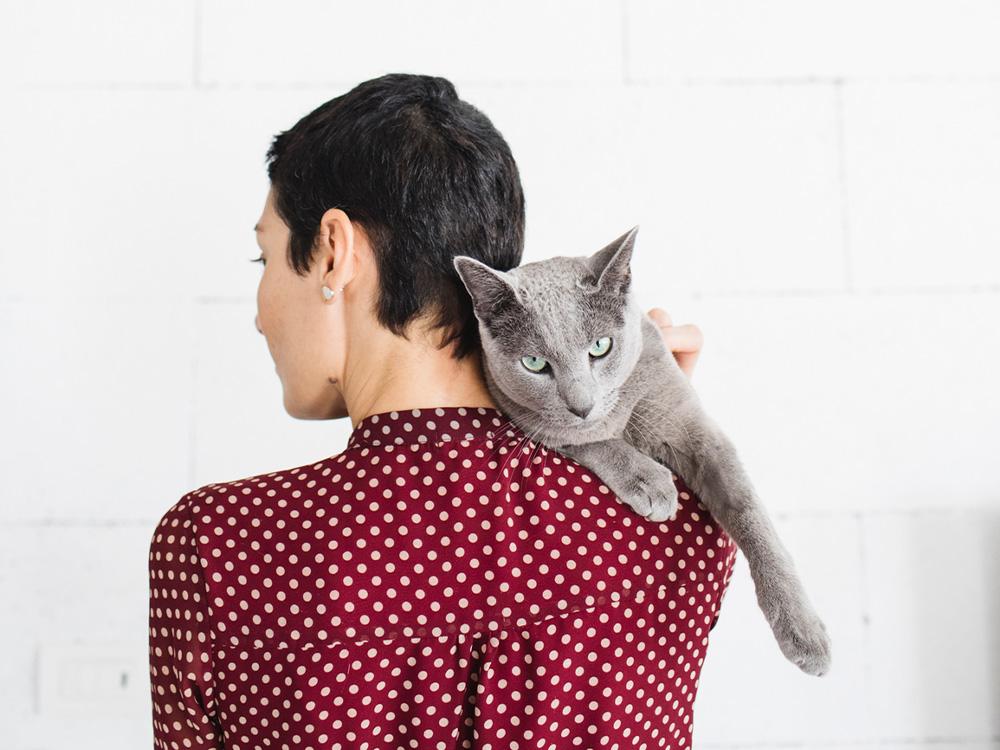 Woman with gray russian blue cat
